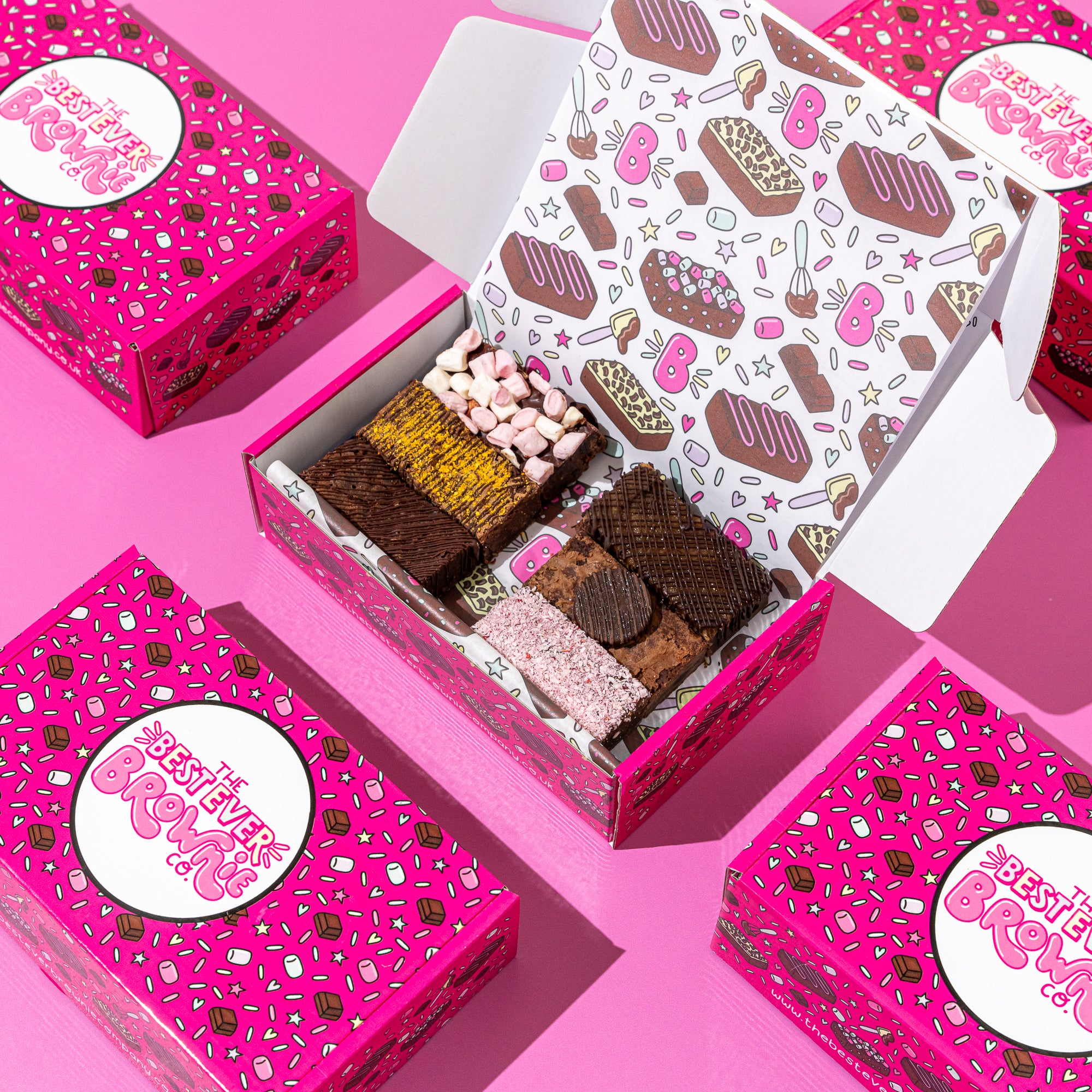 Six deliciously fudgy vegan brownies, mixed flavours, in a decorative and pretty pink postal box and packaging.