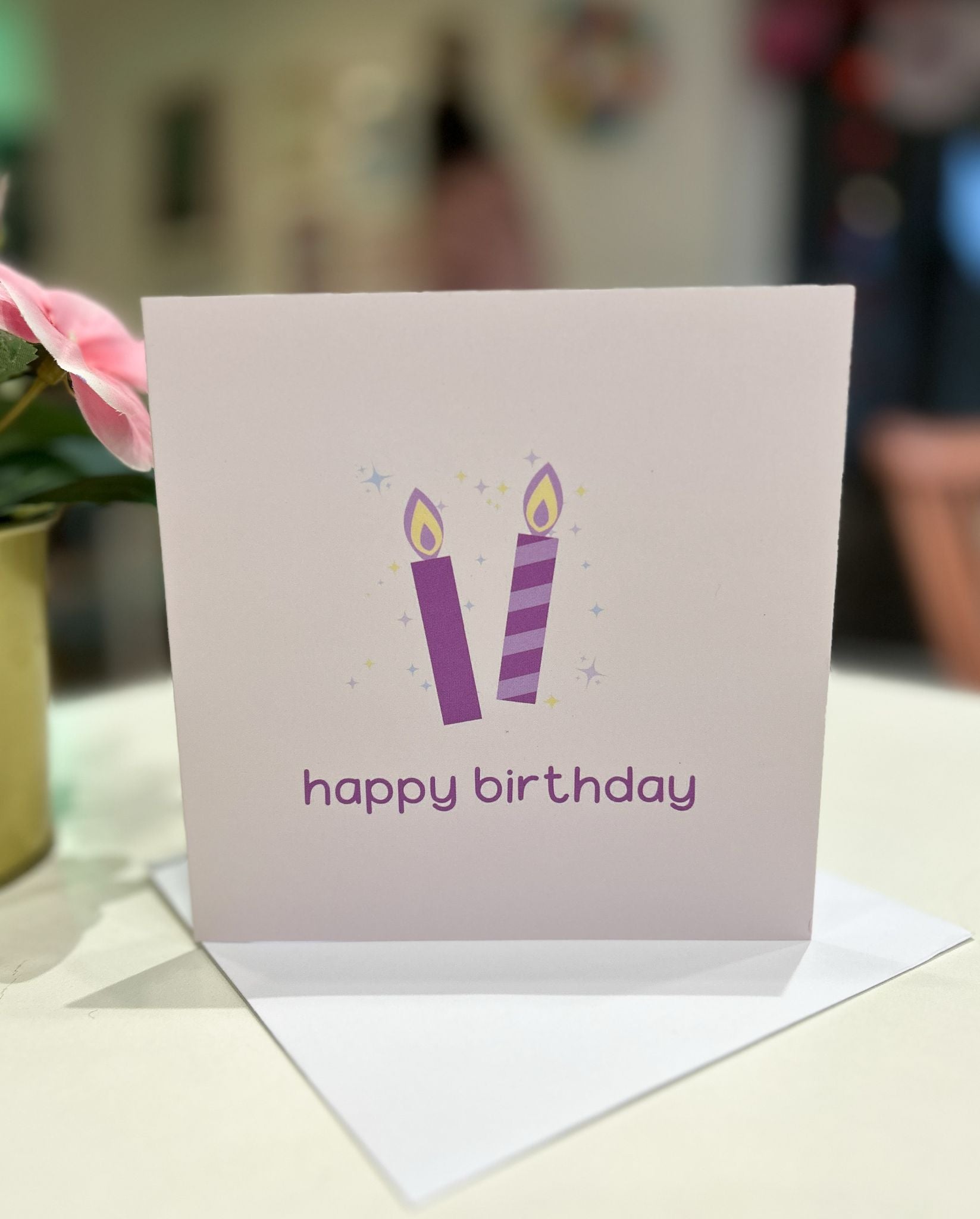 A lovely unisex birthday card with two lilac candles on it.